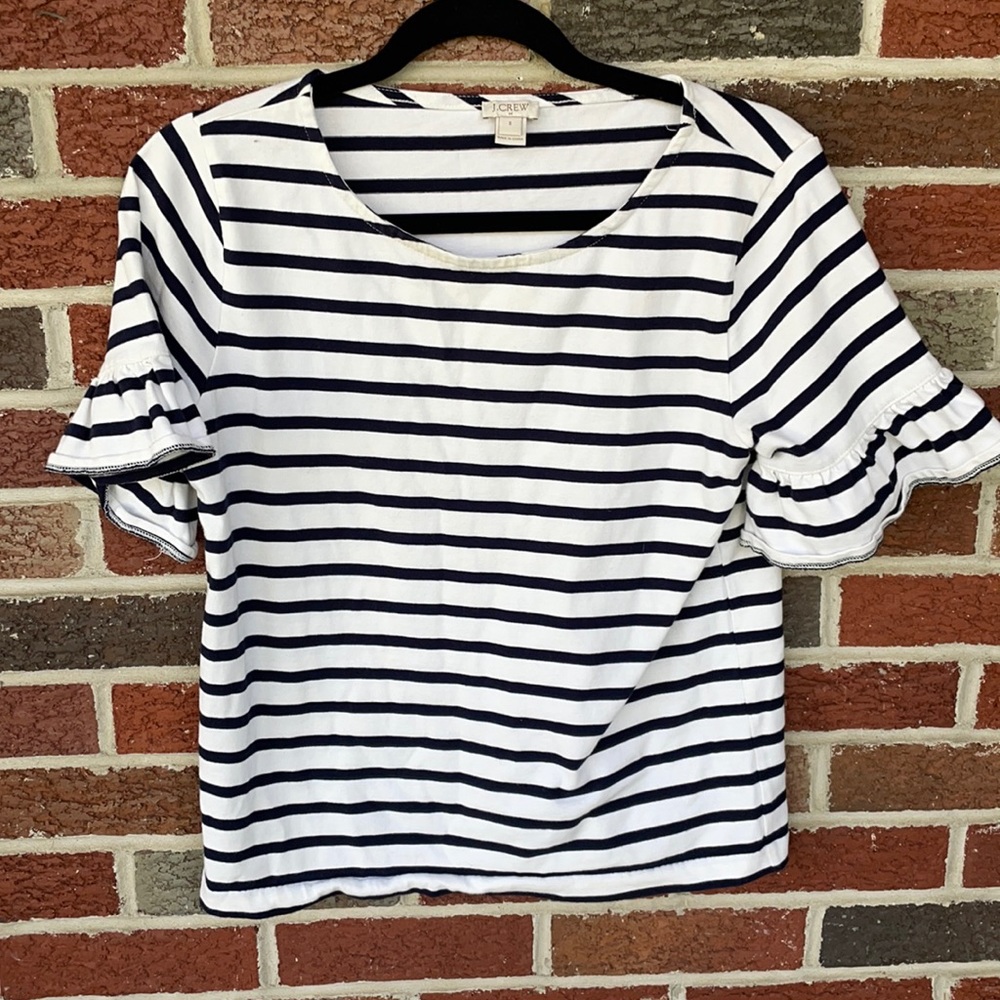 J CREW- White top with navy stripes and ruffles on the arms. Size is a small.